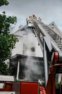 Fire truck extinguishing a house fire. Fire damage restoration and smoke damage restoration will be needed to repair this Vancouver, WA home.
