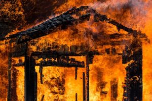 Car garage on fire. Surebuild Restoration restores burned buildings with fire restoration Vancouver homeowners need smoke odor restoration Vancouver as well.