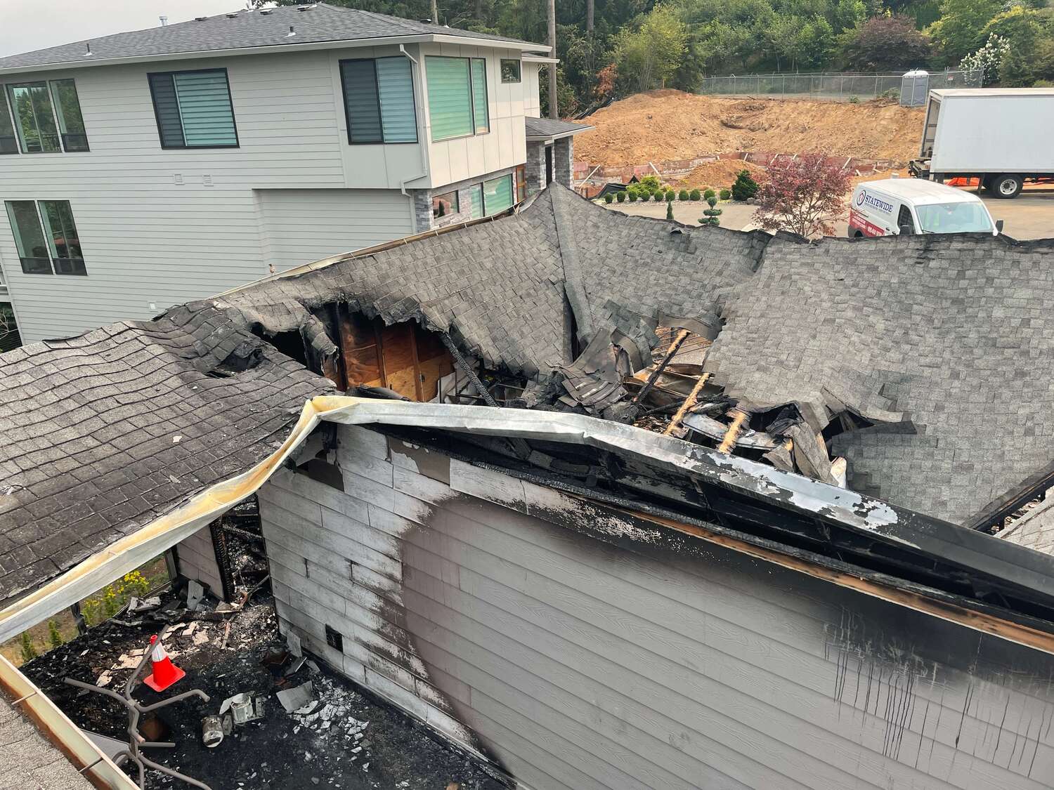 Fire damage restoration in Vancouver, WA — collapsed, burned roof of a home before restoration by SUREBUILD.